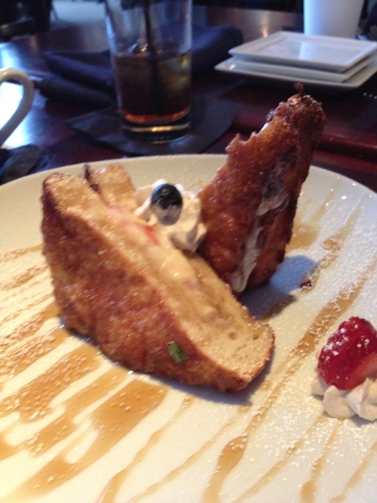 French toast stuffed with berries and cream cheese with homemade syrup